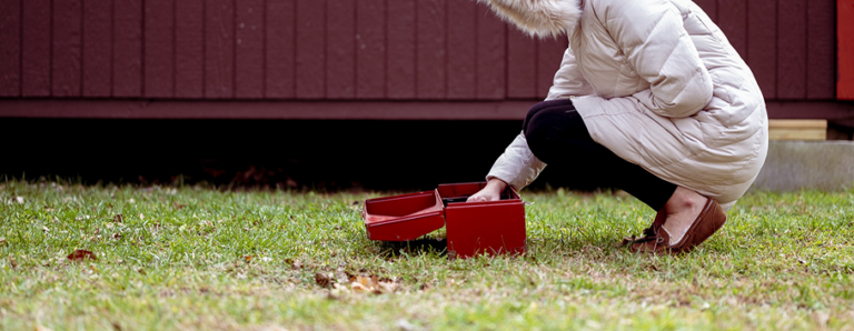 Professional gardening services in Melbourne aerating compacted garden soil during winter to improve drainage and root growth